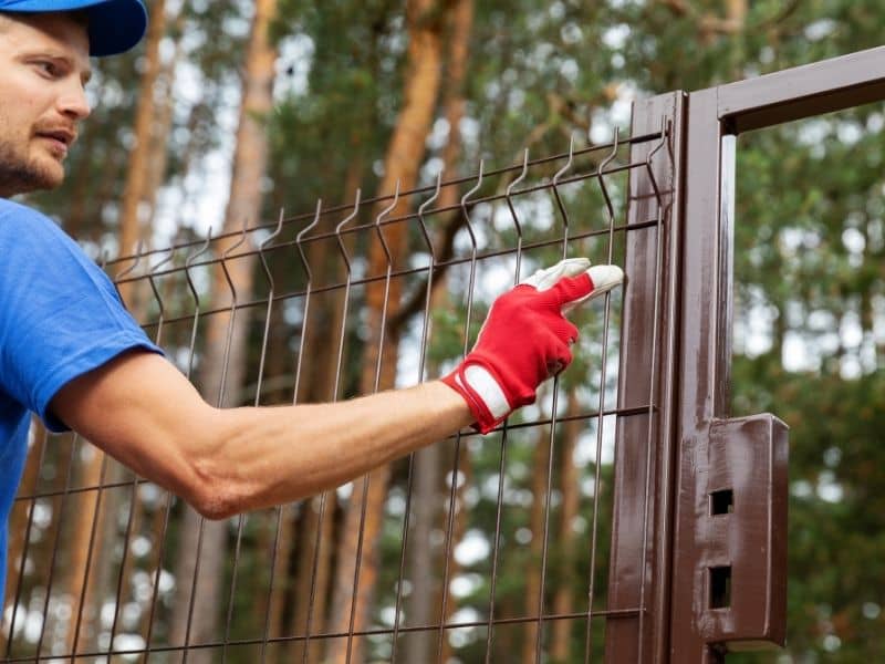 Homeowner installing a fence near a property line where a boundary survey may be needed