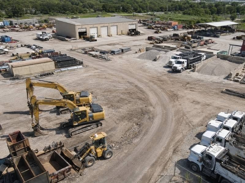 Property Surveyor mapping a contractor yard with heavy equipment and outdoor storage in Grand Prairie Texas